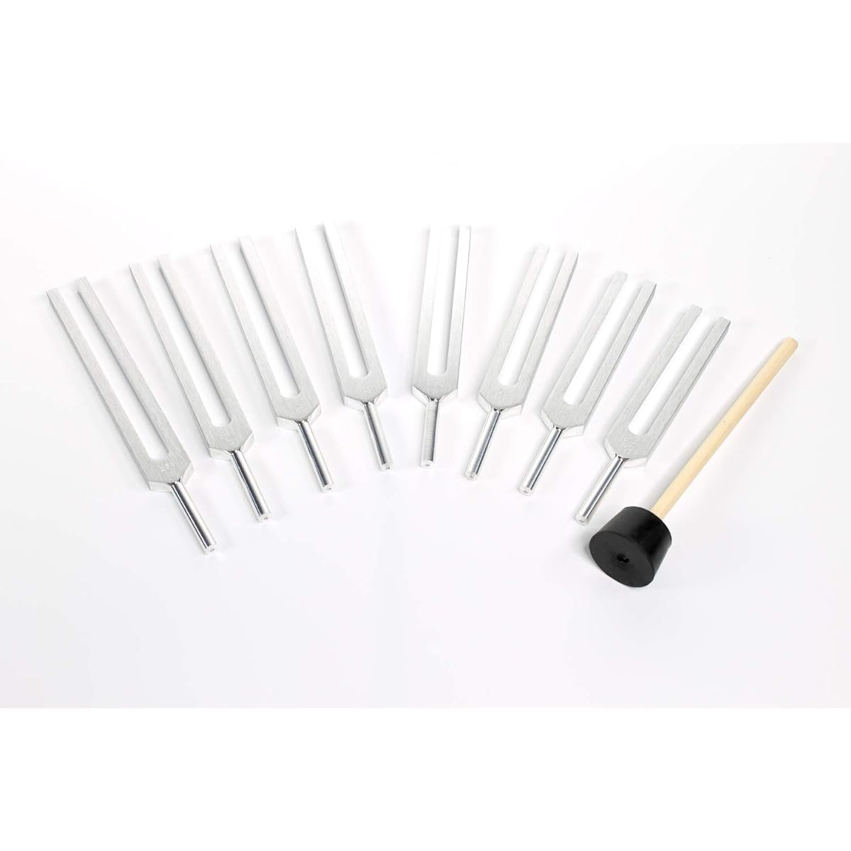 Set of 8 aluminum alloy tuning forks with rubber hammer and protective case.