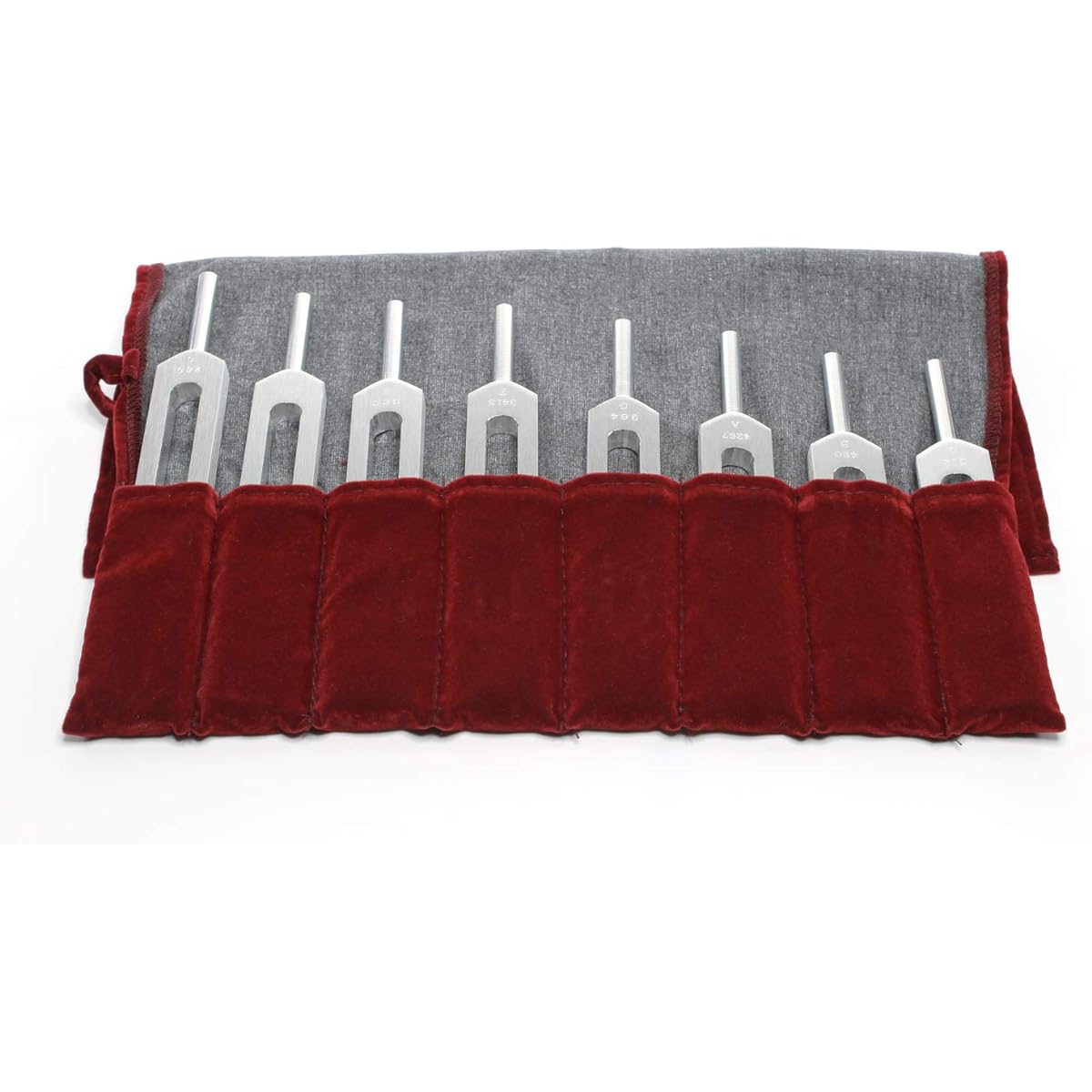Set of 8 aluminum alloy tuning forks with rubber hammer and protective case.