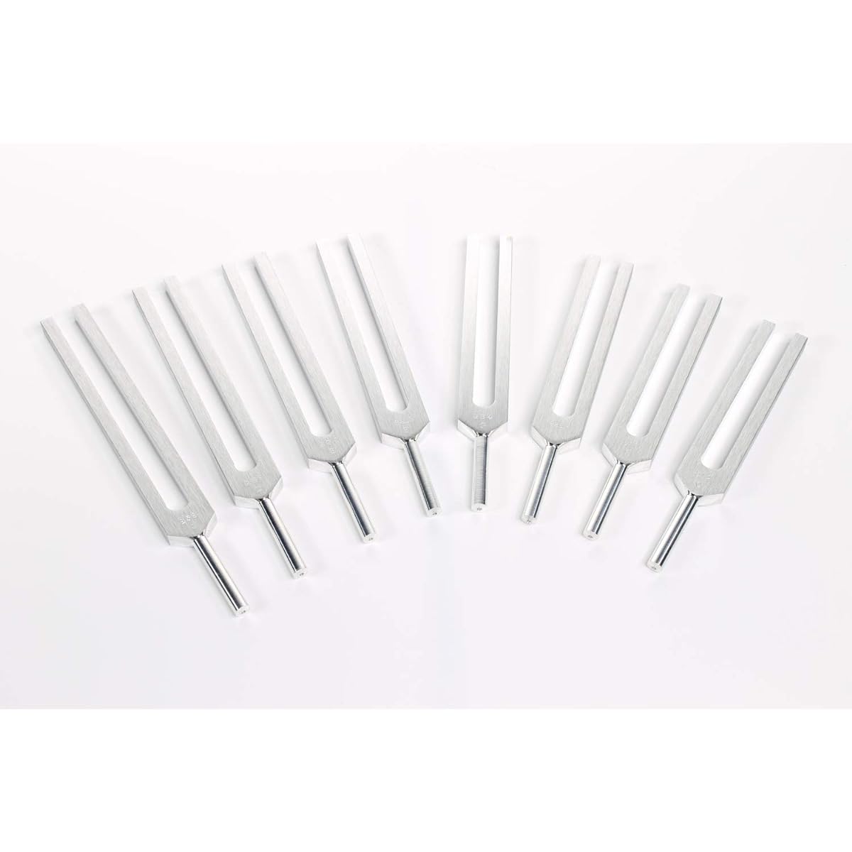 Set of 8 aluminum alloy tuning forks with rubber hammer and protective case.