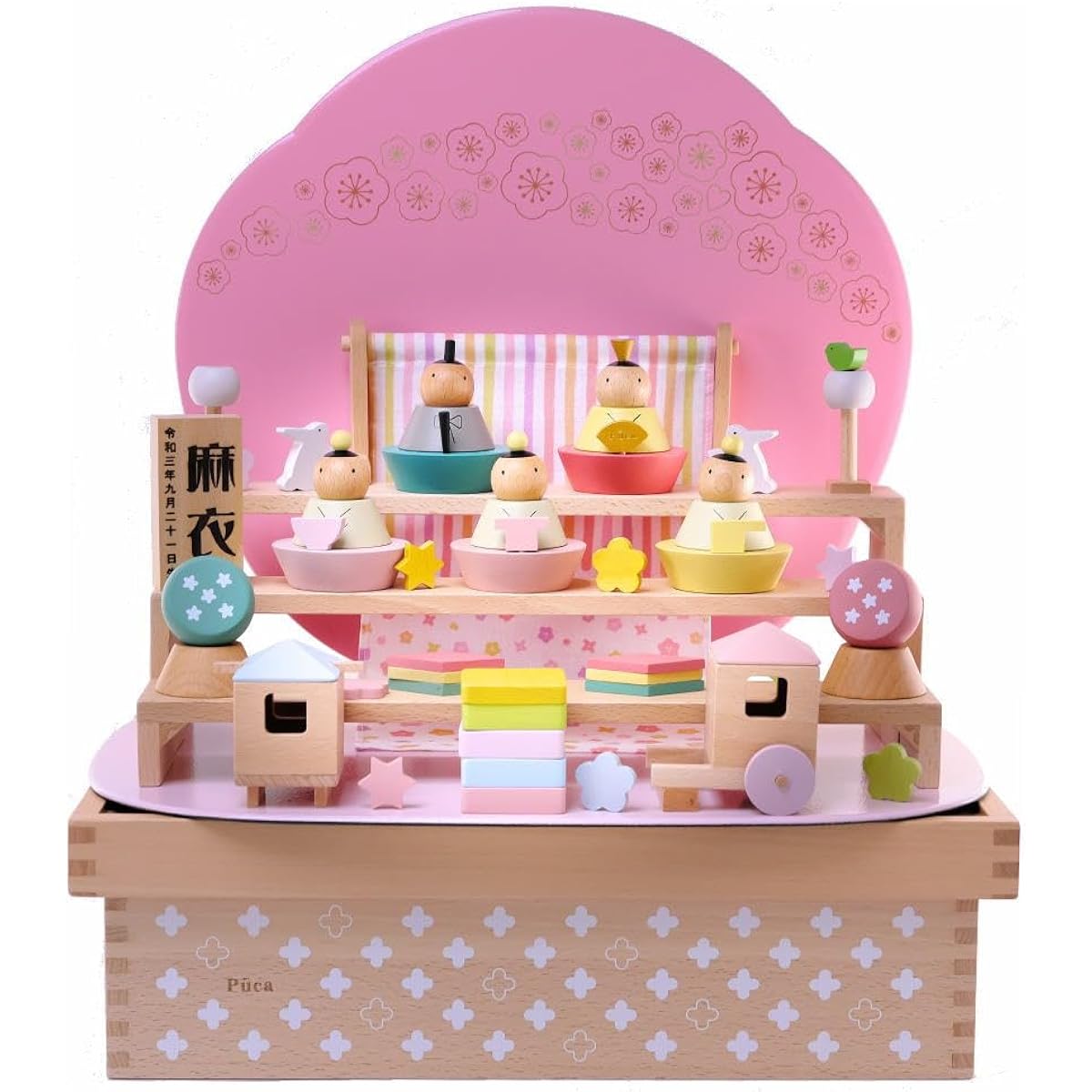 Puka doll in a flower box with a name tag and pink plate