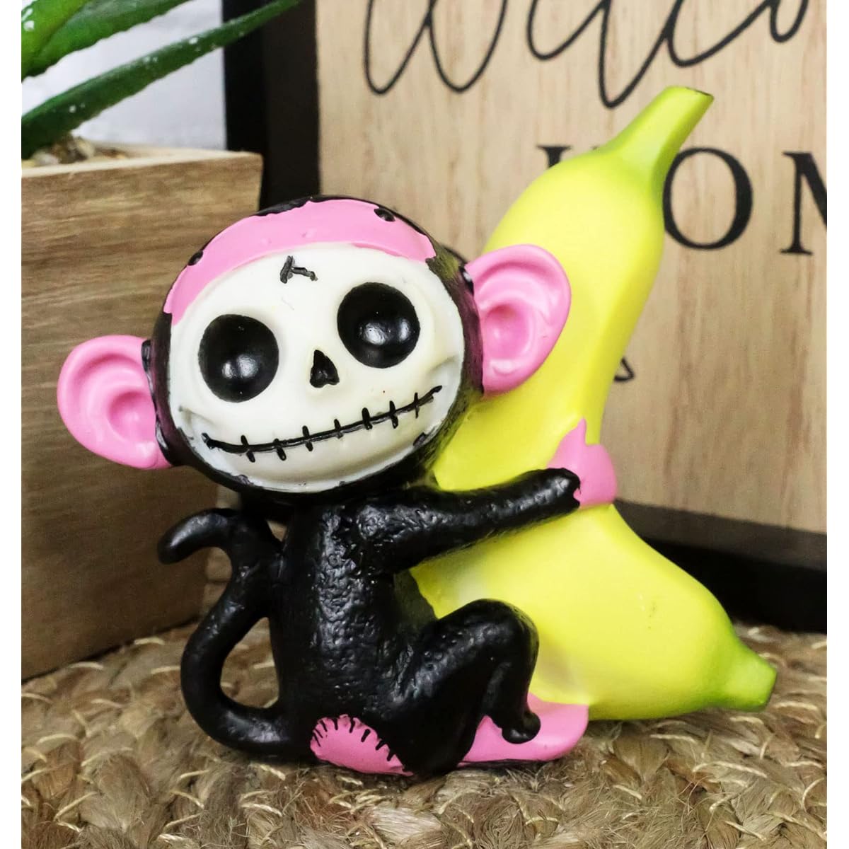 Ebros Tiny Furry Bones Black and Pink Baby Monkey Kiki with Giant Yellow Banana Figurine 3" Tall Collectible Furry Bones Mankey Chimp Skeleton Monster Miniature Sculpture